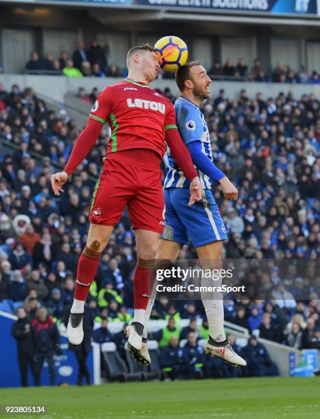 Swansea City's Alfie Mawson battles with Brighton & Hove Albion's Glenn Murray during the Premier League match between Brighton and Hove Albion and...