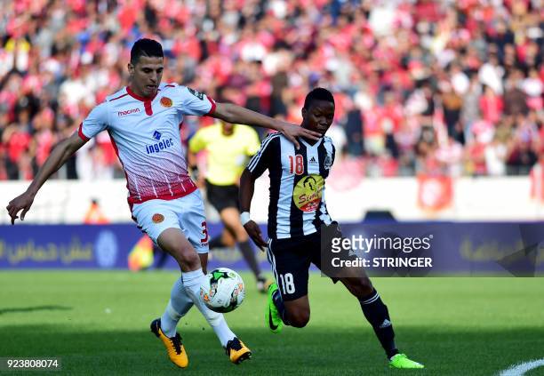 Mazembe's Zambian midfielder Rainford Kalaba vies for the ball against Wydad Casablanca's Moroccan defender Mohamed Nahiri during the 2018 Total CAF...