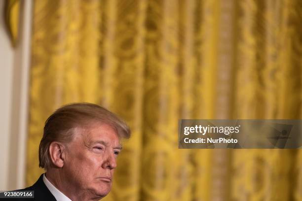 President Donald Trump listens to Prime Minister Malcolm Turnbull of Australia, during their joint press conference, in the East Room of the White...