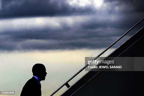 President Barack Obama boards Air Force One at Andrews Air Force Base in Maryland on October 23, 2009 en route to Boston, Massachusetts, where he...