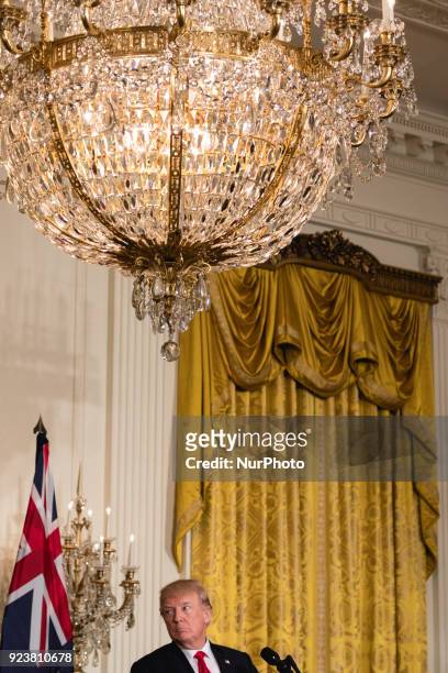 President Donald Trump listens to Prime Minister Malcolm Turnbull of Australia, during their joint press conference, in the East Room of the White...