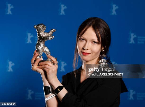 Costume designer Elena Okopnaya poses with her Silver Bear award for outstanding artistic achievement during the awards ceremony of the 68th edition...