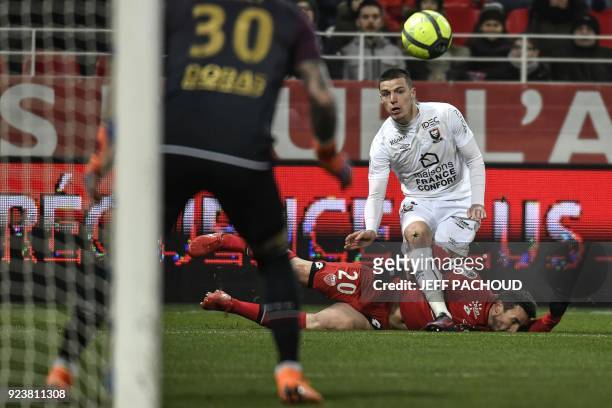 Dijon's French midfielder Romain Amalfitano vies with Caen's French defender Frederic Guilbert during the French L1 football match Dijon vs Stade...