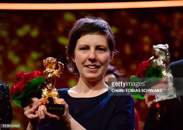 Romanian director Adina Pintilie holds her Golden Bear for Best Film she was awarded for the movie "Touch Me Not" during the awards ceremony of the...