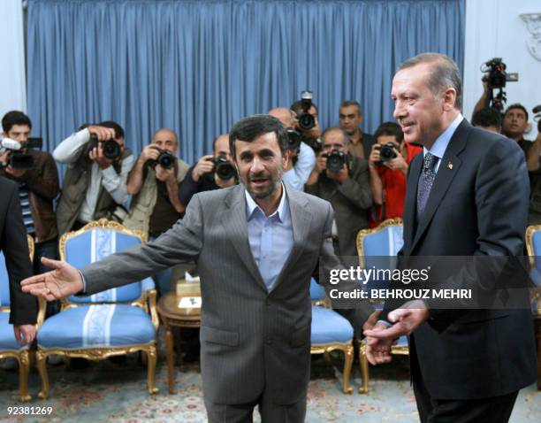 Iranian President Mahmoud Ahmadinejad welcomes Turkish Prime Minister Recep Tayyip Erdogan at his office in Tehran on October 27, 2009. Erdogan is on...