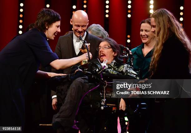 Romanian director Adina Pintilie gives the Golden Bear for Best Film she was awarded for the movie "Touch Me Not" to actor Christian Bayerlein as...