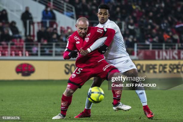 Caen's French Defender Yoel Armougom vies with Dijon's French midfielder Florent Balmont during the French L1 football match Dijon vs Stade Malherbe...