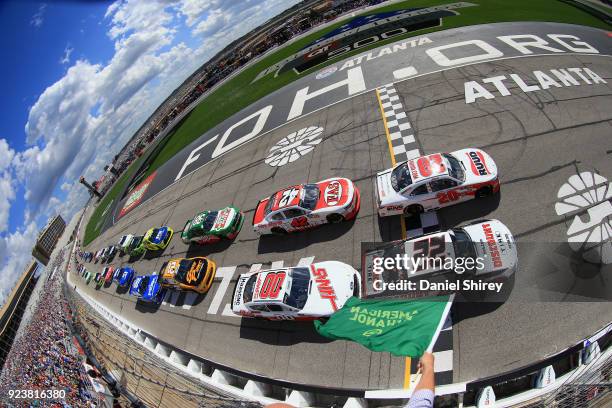 Christopher Bell, driver of the Ruud Toyota, and Joey Logano, driver of the Discount Tire Ford, lead the field to the green flag to start the NASCAR...