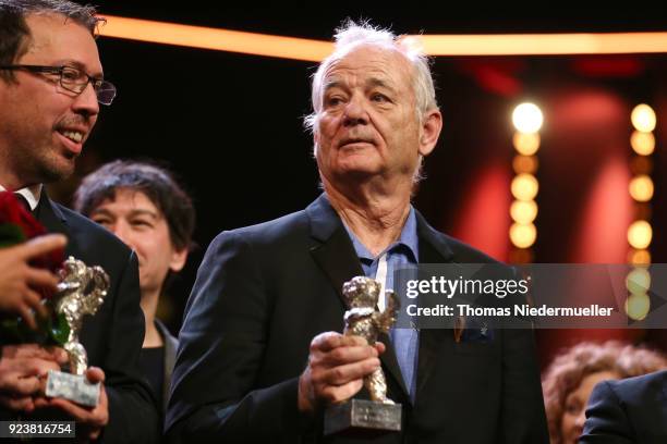 Bill Murray poses with the Silver Bear for Best Director Wes Anderson for 'Isle of Dogs' on stage at the closing ceremony during the 68th Berlinale...