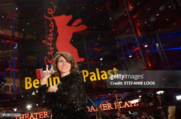 Polish director and screenwriter Malgorzata Szumowska poses with her Silver Bear Grand Jury Prize trophy she was awarded for the movie "Mug" as she...