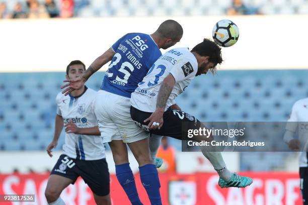 Os Belenenses defender Nuno Tomas from Portugal vies with Feirense defender Tiago Gomes from Portugal for the ball possession during the Primeira...