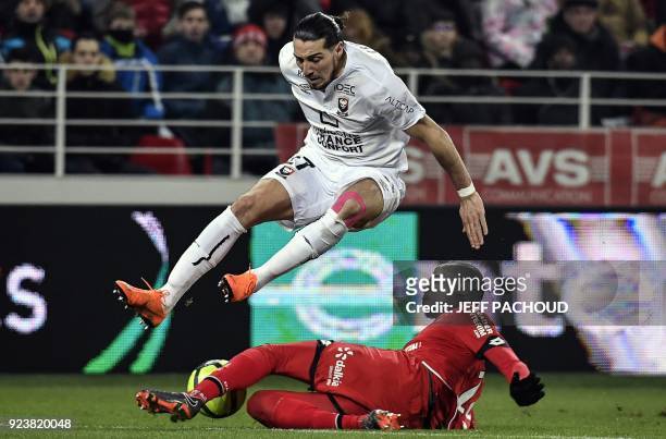 Caen's French forward Enzo Crivelli is tackled by Dijon's Center African midfielder Cedric Yambere during the French L1 football match Dijon vs Stade...