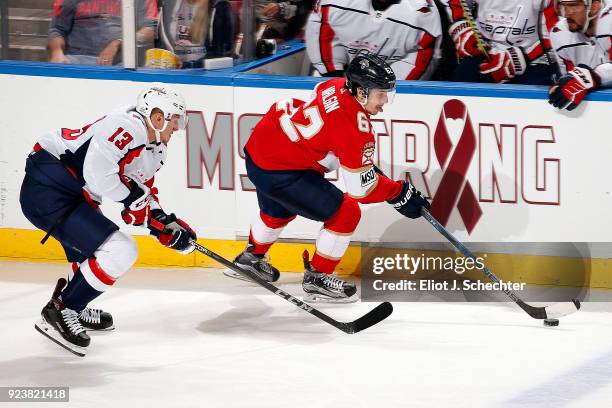 Denis Malgin of the Florida Panthers skates with the puck against Jakub Vrana of the Washington Capitals at the BB&T Center on February 22, 2018 in...