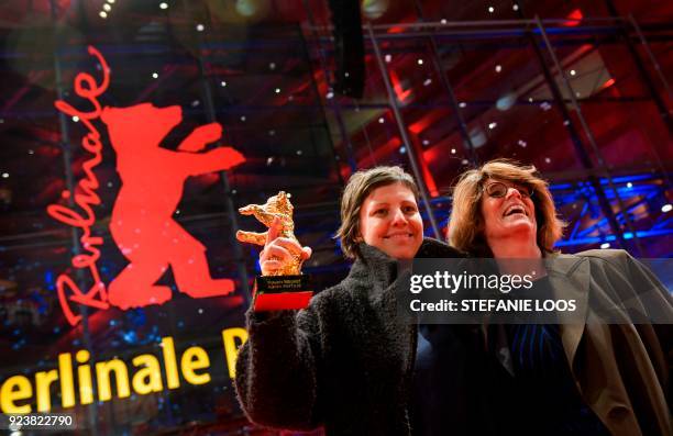 Romanian director Adina Pintilie and British actress Laura Benson pose with the Golden Bear award received for Best Film for "Touch Me Not" after the...