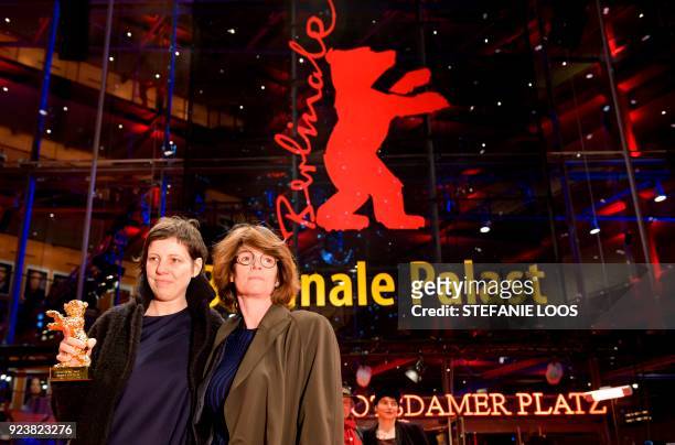 Romanian director Adina Pintilie and British actress Laura Benson pose with the Golden Bear award received for Best Film for "Touch Me Not" after the...