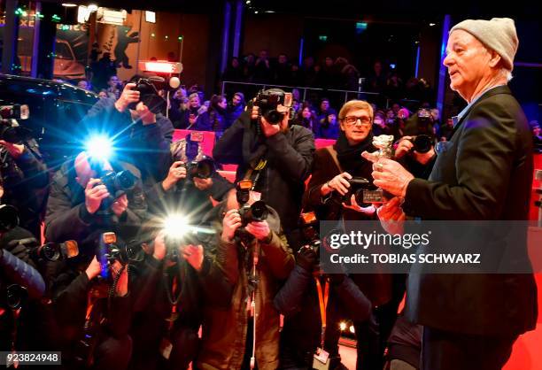 Actor Bill Murray shows the Silver Bear for Best Director award received on behalf of Wes Anderson for the movie "Isle of Dogs" at the end of the...