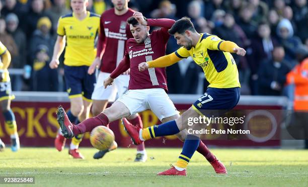 Alex Mowatt of Oxford United has a shot at goal past Brendan Moloney of Northampton Town during the Sky Bet League One match between Northampton Town...