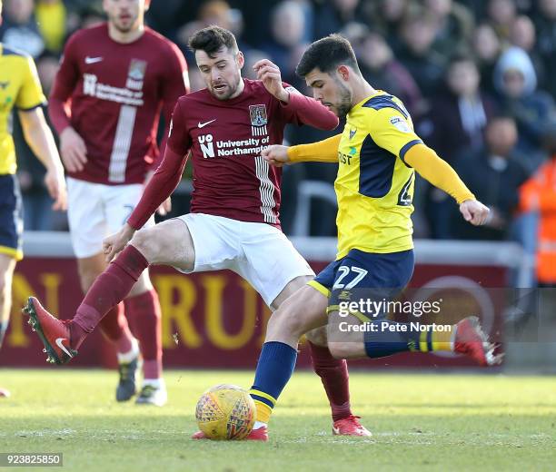 Alex Mowatt of Oxford United has a shot at goal past Brendan Moloney of Northampton Town during the Sky Bet League One match between Northampton Town...