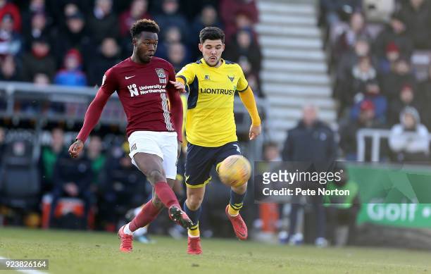 Gboly Ariyibi of Northampton Town plays the ball watched by Alex Mowett of Oxford United during the Sky Bet League One match between Northampton Town...