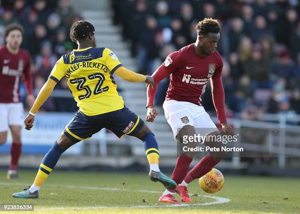 Gboly Ariyibi of Northampton Town contests the ball with Isaac Buckley-Ricketts of Oxford United during the Sky Bet League One match between...