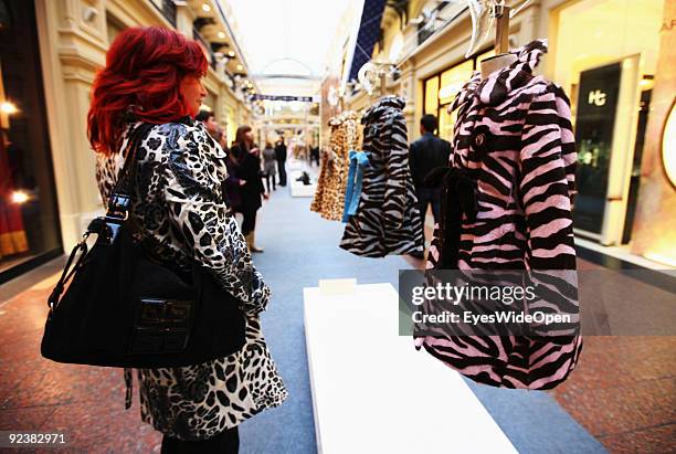 Russian woman looks for a modern coat in the huge famous and exclusive GUM Shopping Mall on the Red Square on October 14, 2009 in Moscow, Russia....