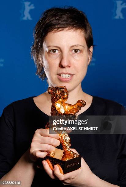 Romanian director, screenwriter, editor and producer Adina Pintilie poses with her Golden Bear award for Best Film for her film "Touch Me Not" after...