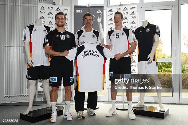 Michael Kraus, head coach Heiner Brand and Dominik Klein present the new national shirt during Team presentation of the German Handball National Team...