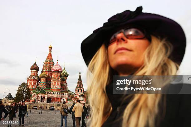 Young woman in front of the Cathedral of Saint Basil on the Red Square on October 14, 2009 in Moscow, Russia. The russian orthodox cathedral was...