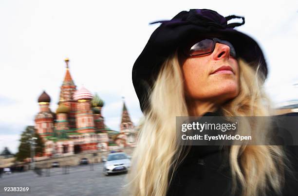 Young woman in front of the Cathedral of Saint Basil on the Red Square on October 14, 2009 in Moscow, Russia. The russian orthodox cathedral was...