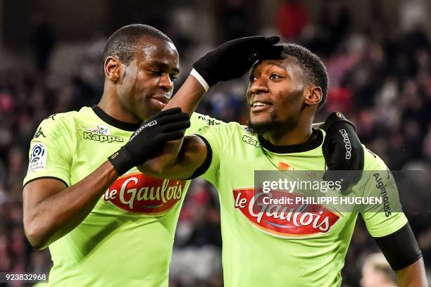 Angers' Cameroun forward Karl Toko Ekambi is congratulated by a teammate after scoring a goal during the French L1 football match Lille vs Angers on...