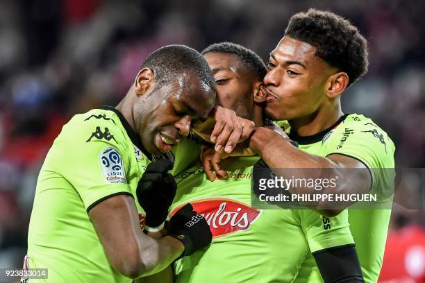 Angers' Cameroun forward Karl Toko Ekambi is congratulated by teammates after scoring a goal during the French L1 football match Lille vs Angers on...