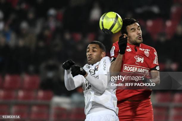 Dijon's Tunisian defender Oussama Haddadi vies with Caen's French forward Sylvio Ronny Rodelin during the French L1 football match Dijon vs Stade...