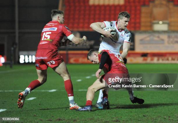 Ulster's Andrew Trimble is tackled by Scarlets' Ioan Nicholas during the Guinness Pro14 Round 16 match between Scarlets and Ulster Rugby at Parc y...