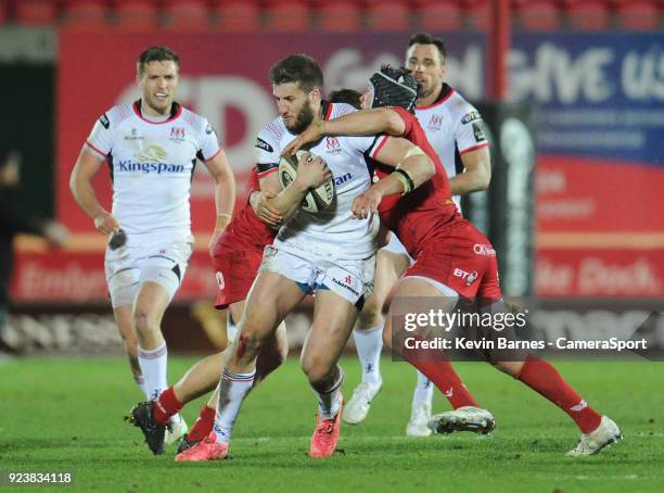 Ulster's Stuart McCloskey is tackled by Scarlets' Ryan Elias during the Guinness Pro14 Round 16 match between Scarlets and Ulster Rugby at Parc y...