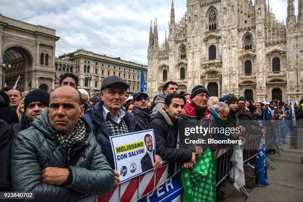 Attendees hold signs and gather during an election campaign rally for The League party at Duomo Square in Milan, Italy, on Saturday, Feb. 24, 2018....