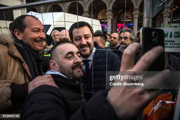 Matteo Salvini, leader of the euroskeptic party League, center, takes a selfie photograph with attendees after an election campaign rally at Duomo...