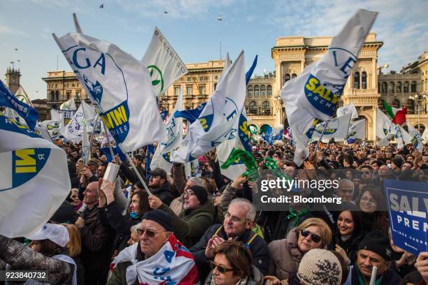 Attendees wave flags and gather during an election campaign rally for The League party at Duomo Square in Milan, Italy, on Saturday, Feb. 24, 2018....