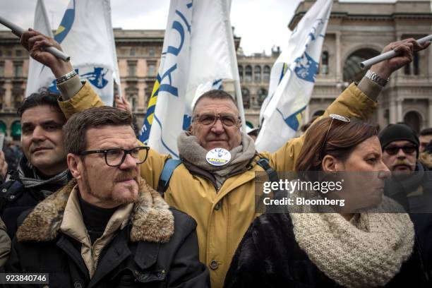 Attendees wave flags and gather during an election campaign rally for The League party at Duomo Square in Milan, Italy, on Saturday, Feb. 24, 2018....