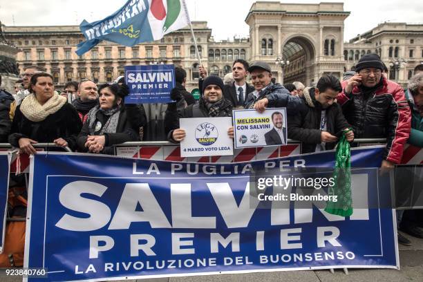 Attendees hold signs and gather during an election campaign rally for The League party at Duomo Square in Milan, Italy, on Saturday, Feb. 24, 2018....