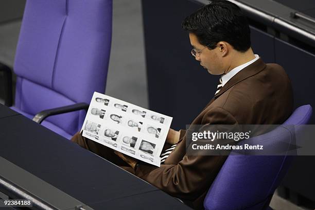 Health Minister designate Philipp Roesler of the German Free Democrats reads at the first session of the new Bundestag on October 27, 2009 in Berlin,...