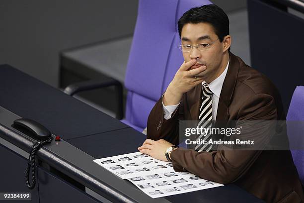 Health Minister designate Philipp Roesler of the German Free Democrats reads at the first session of the new Bundestag on October 27, 2009 in Berlin,...