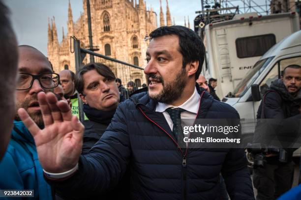 Matteo Salvini, leader of the euroskeptic party League, center, speaks with attendees after an election campaign rally at Duomo Square in Milan,...