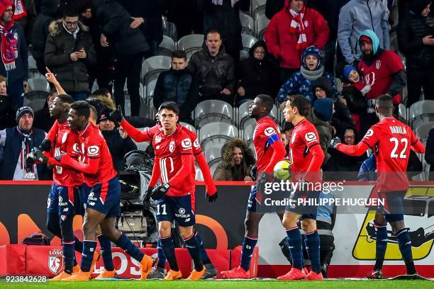 Lille's Ivorian forward Nicolas Pepe is congratulated by his teammates after scoring a goal during the French L1 football match Lille vs Angers on...