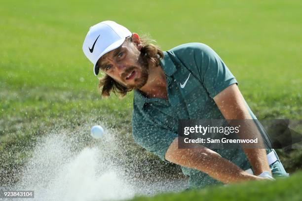 Tommy Fleetwood of England plays a shot out of the bunker on the sixth hole during the third round of the Honda Classic at PGA National Resort and...