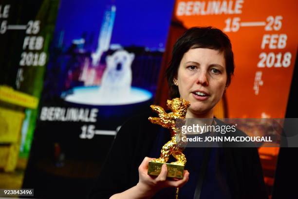 Romanian director Adina Pintilie poses with the Golden Bear for Best Film she was awarded for the movie "Touch Me Not" during a press conference...