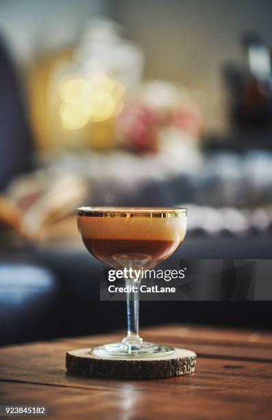 espresso martini cocktail on coffee table in indoor setting - espresso martini stock pictures, royalty-free photos & images