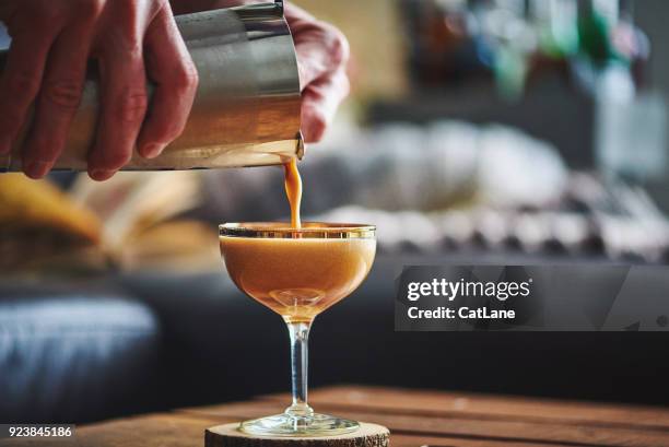 Male Hands Pouring Espresso Martini Cocktail Into Glass High-Res Stock Photo