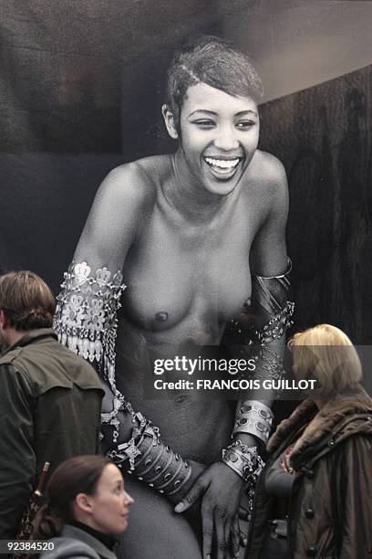 People look at a photograph by German fashion photographer Peter Lindbergh showing British top model Naomi Campbell during the 36th international...