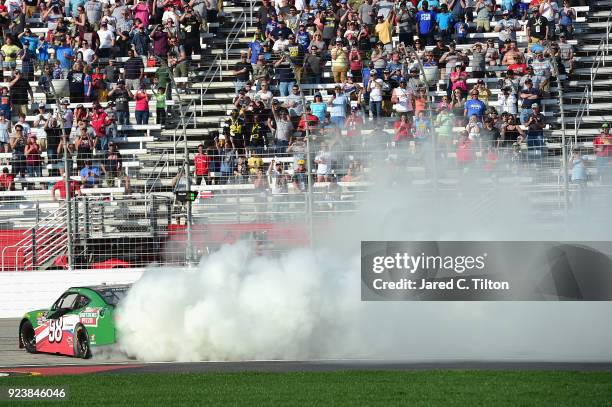 Kevin Harvick, driver of the Hunt Brothers Pizza Ford, celebrates with a burnout after winning the NASCAR Xfinity Series Rinnai 250 at Atlanta Motor...