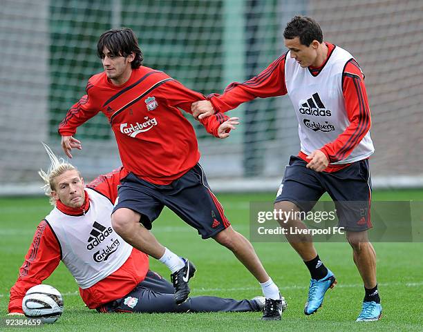 Alberto Aquilani goes past Andriy Voronin and Phillipp Degan during a training session at Melwood Training Ground on October 27, 2009 in Liverpool...